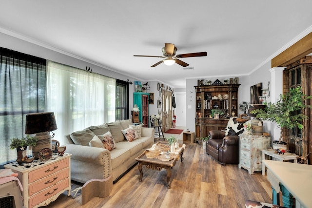 6199 State Highway 22, Hillsboro, TX 76645 - living room featuring a ceiling fan, wood finished floors, and ornamental molding