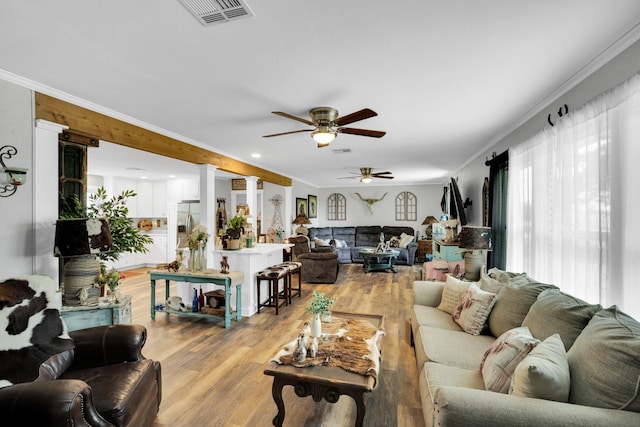 6199 State Highway 22, Hillsboro, TX 76645 - living area featuring a ceiling fan, light wood-style flooring, and crown molding