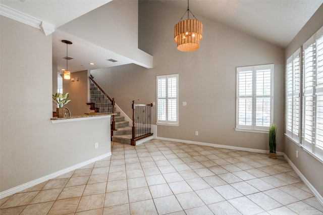 1615 Georgetown Dr, Allen, TX 75013 - empty room with a chandelier, stairway, light tile patterned floors, high vaulted ceiling, and baseboards
