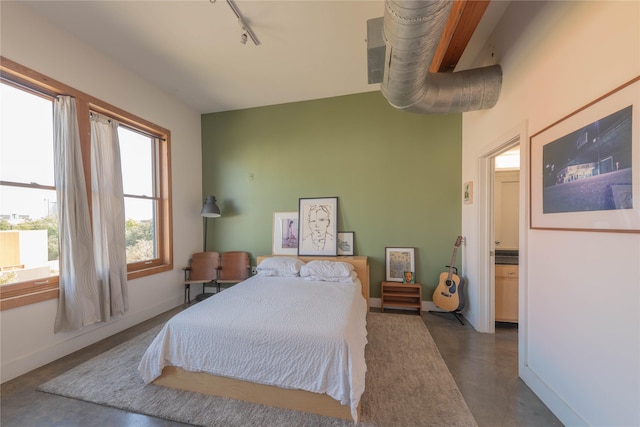 2502 Live Oak St Unit 314, Dallas, TX 75204 - bedroom with concrete flooring, rail lighting, and baseboards