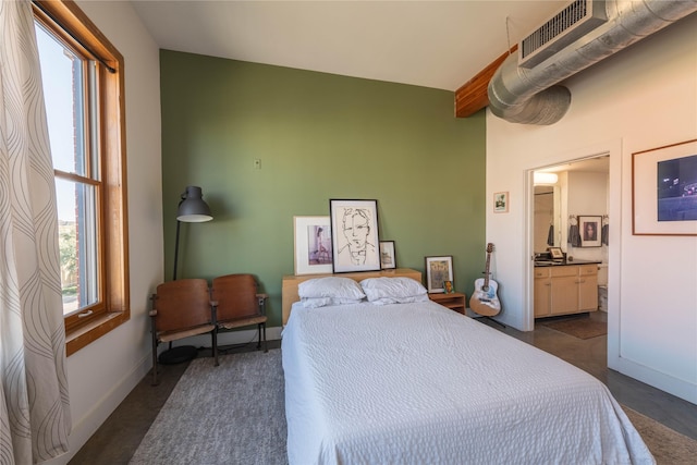 2502 Live Oak St Unit 314, Dallas, TX 75204 - bedroom with baseboards and connected bathroom