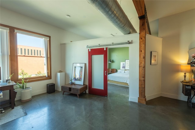 2502 Live Oak St Unit 314, Dallas, TX 75204 - living area with finished concrete flooring, baseboards, and a barn door