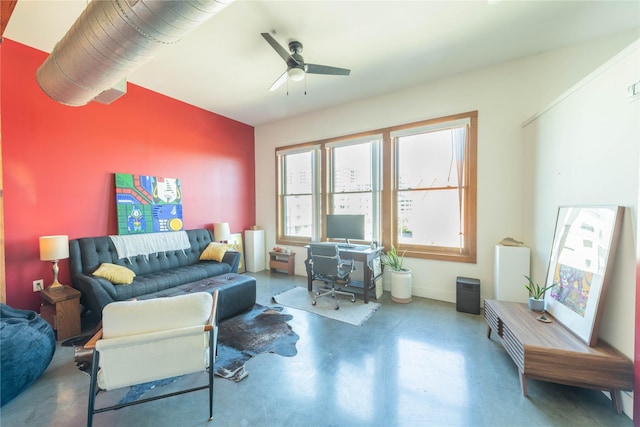 2502 Live Oak St Unit 314, Dallas, TX 75204 - living room with finished concrete floors, ceiling fan, a desk, and baseboards