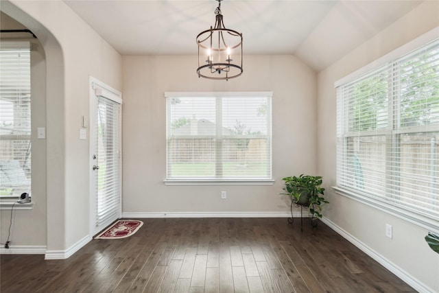 307 Acadia Ln, Forney, TX 75126 - unfurnished dining area with healthy amount of natural light, a chandelier, dark wood-style flooring, and arched walkways