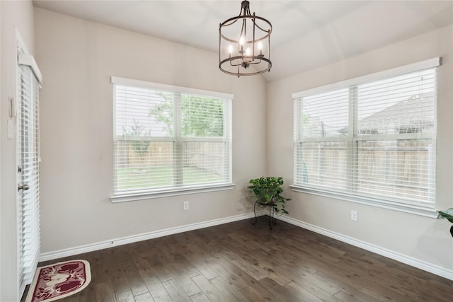 307 Acadia Ln, Forney, TX 75126 - unfurnished dining area with a chandelier, dark wood finished floors, plenty of natural light, and baseboards
