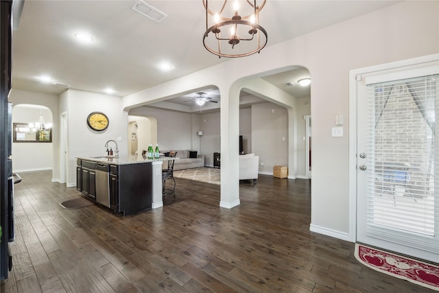 307 Acadia Ln, Forney, TX 75126 - kitchen with arched walkways, a chandelier, open floor plan, a sink, and a breakfast bar