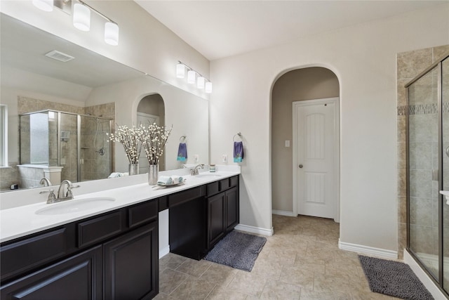 307 Acadia Ln, Forney, TX 75126 - bathroom with a shower stall, double vanity, and baseboards