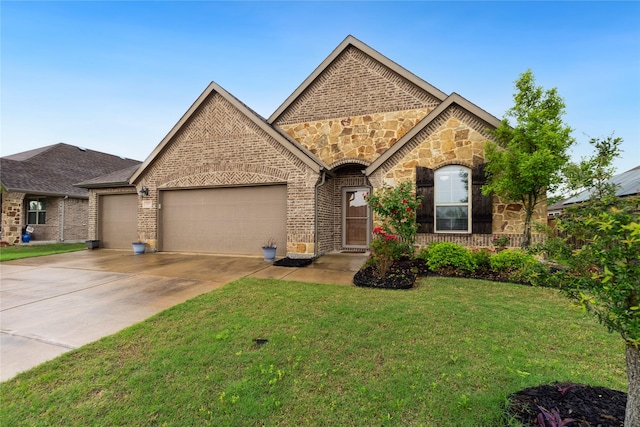 307 Acadia Ln, Forney, TX 75126 - french provincial home featuring a garage, concrete driveway, stone siding, a front lawn, and brick siding