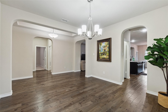 307 Acadia Ln, Forney, TX 75126 - unfurnished room featuring arched walkways, dark wood-style floors, baseboards, and a sink