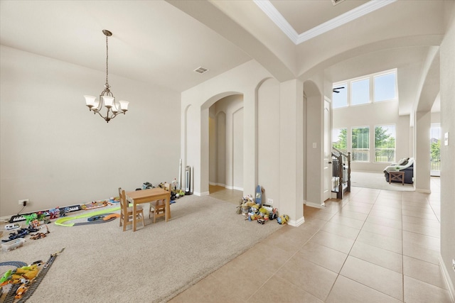 211 Crestbrook Dr, Rockwall, TX 75087 - rec room featuring arched walkways, a chandelier, light tile patterned floors, ornamental molding, and baseboards
