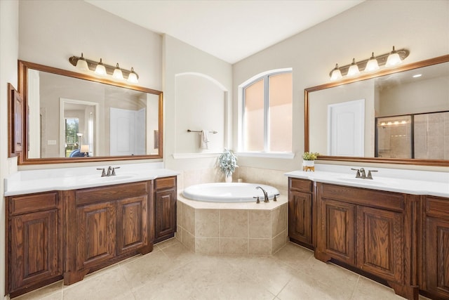 211 Crestbrook Dr, Rockwall, TX 75087 - full bathroom with two vanities, a garden tub, and tile patterned flooring