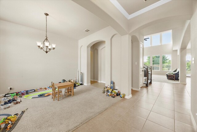 211 Crestbrook Dr, Rockwall, TX 75087 - recreation room featuring arched walkways, light tile patterned floors, a chandelier, and ornamental molding