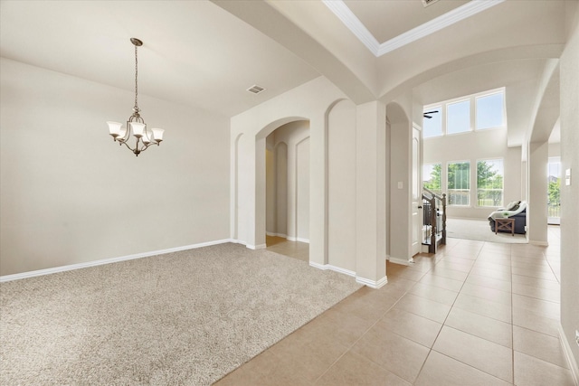 211 Crestbrook Dr, Rockwall, TX 75087 - spare room featuring arched walkways, light colored carpet, crown molding, a chandelier, and light tile patterned floors