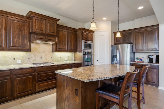 211 Crestbrook Dr, Rockwall, TX 75087 - kitchen with stainless steel appliances, light tile patterned flooring, light stone counters, a kitchen bar, and recessed lighting