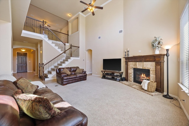 211 Crestbrook Dr, Rockwall, TX 75087 - living area featuring arched walkways, stairway, a towering ceiling, carpet floors, and baseboards