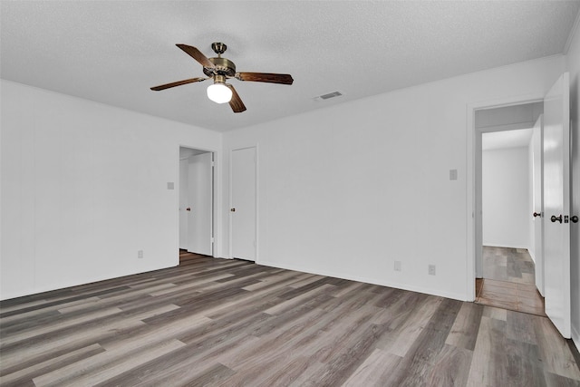 412 Lee Blvd, Pottsboro, TX 75076 - spare room with wood finished floors, ceiling fan, and a textured ceiling