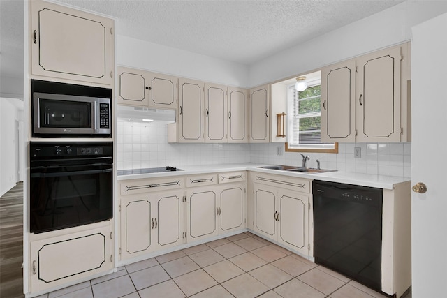 412 Lee Blvd, Pottsboro, TX 75076 - kitchen featuring black appliances, a sink, under cabinet range hood, light countertops, and a textured ceiling