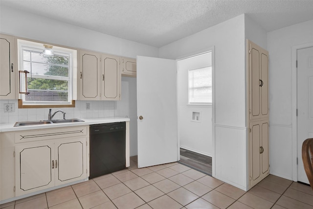 412 Lee Blvd, Pottsboro, TX 75076 - kitchen featuring dishwasher, a sink, light countertops, a textured ceiling, and cream cabinetry