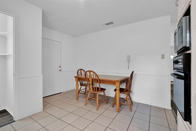 412 Lee Blvd, Pottsboro, TX 75076 - dining space featuring a textured ceiling and light tile patterned floors