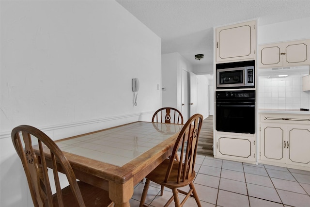 412 Lee Blvd, Pottsboro, TX 75076 - dining room featuring light tile patterned flooring and a textured ceiling