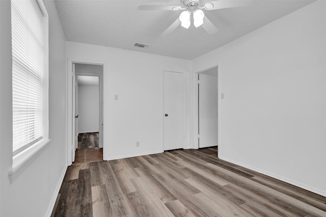 412 Lee Blvd, Pottsboro, TX 75076 - unfurnished bedroom featuring a textured ceiling, wood finished floors, baseboards, and a ceiling fan