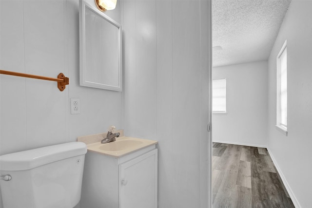 412 Lee Blvd, Pottsboro, TX 75076 - half bath with a textured ceiling, vanity, toilet, and wood finished floors