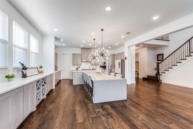 8416 Shoreacres Dr, Mckinney, TX 75070 - kitchen with a large island, dark wood-type flooring, light countertops, a chandelier, and recessed lighting