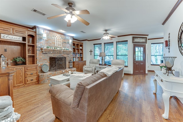 4402 Running Brook Dr, Rowlett, TX 75088 - living area with ceiling fan, ornamental molding, light wood-style floors, a brick fireplace, and built in shelves