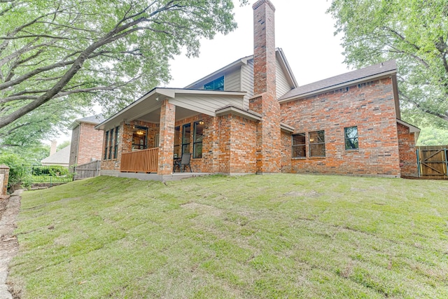 4402 Running Brook Dr, Rowlett, TX 75088 - rear view of property with brick siding, a chimney, and a porch