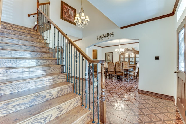 4402 Running Brook Dr, Rowlett, TX 75088 - foyer entrance with a chandelier, arched walkways, stairs, ornamental molding, and baseboards