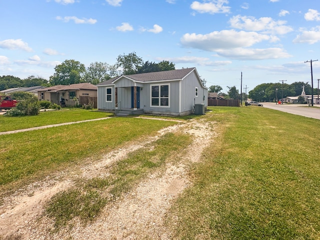 1209 N Morris St, Gainesville, TX 76240 - view of front of property featuring central AC, driveway, and board and batten siding