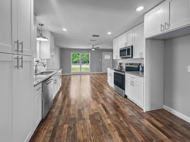 1209 N Morris St, Gainesville, TX 76240 - kitchen with appliances with stainless steel finishes, a sink, backsplash, ceiling fan, and recessed lighting