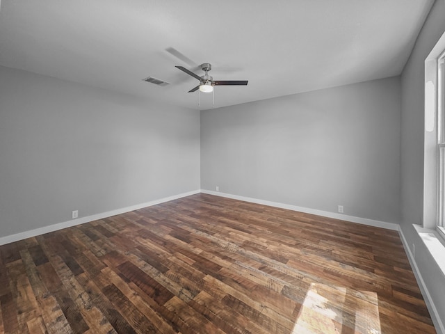 1209 N Morris St, Gainesville, TX 76240 - spare room featuring dark wood-style flooring, ceiling fan, and baseboards