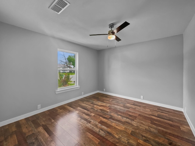 1209 N Morris St, Gainesville, TX 76240 - spare room featuring ceiling fan, dark wood-style flooring, and baseboards