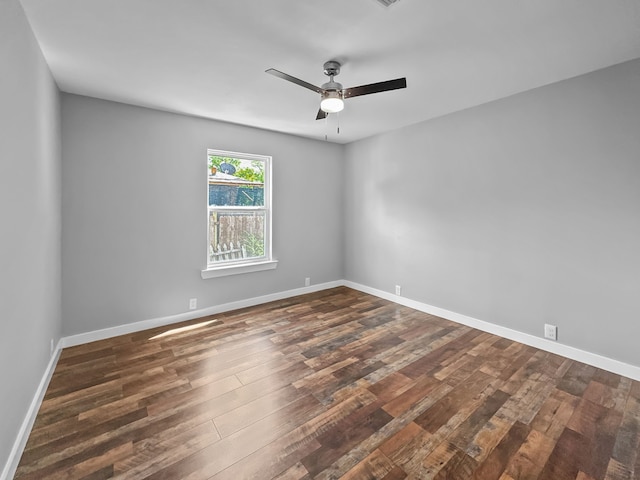 1209 N Morris St, Gainesville, TX 76240 - empty room with a ceiling fan, dark wood-style flooring, and baseboards