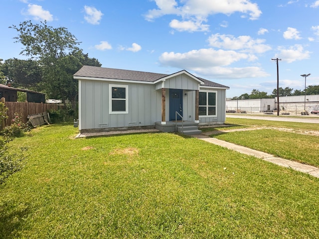 1209 N Morris St, Gainesville, TX 76240 - view of front of property featuring board and batten siding and roof with shingles