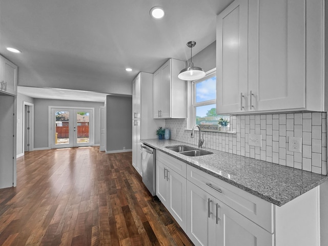 1209 N Morris St, Gainesville, TX 76240 - kitchen featuring a sink, stainless steel dishwasher, baseboards, white cabinets, and dark wood-style floors