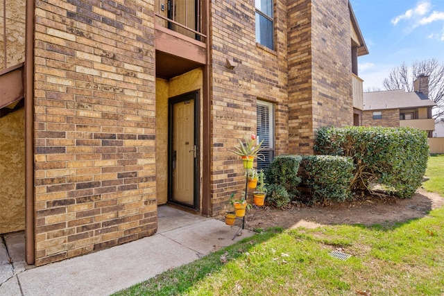 1104 Harwell Dr Unit 1514, Arlington, TX 76011 - view of exterior entry with brick siding and a balcony