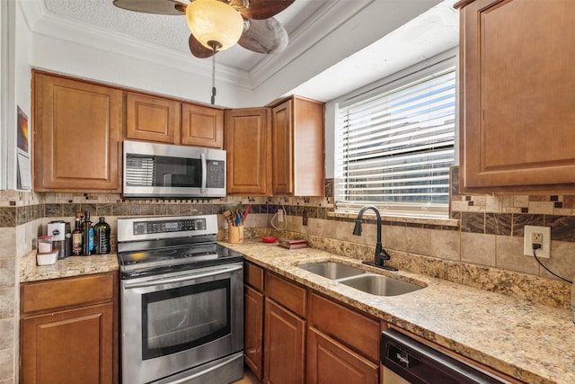 1104 Harwell Dr Unit 1514, Arlington, TX 76011 - kitchen featuring appliances with stainless steel finishes, a sink, decorative backsplash, light stone counters, and ornamental molding