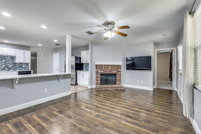 12748 Gillon Dr, Frisco, TX 75035 - unfurnished living room with a ceiling fan, recessed lighting, baseboards, wood finished floors, and a sink