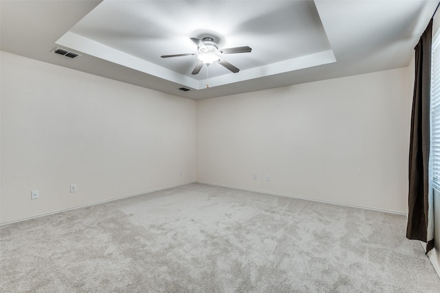12748 Gillon Dr, Frisco, TX 75035 - empty room featuring a tray ceiling, carpet flooring, a ceiling fan, and baseboards