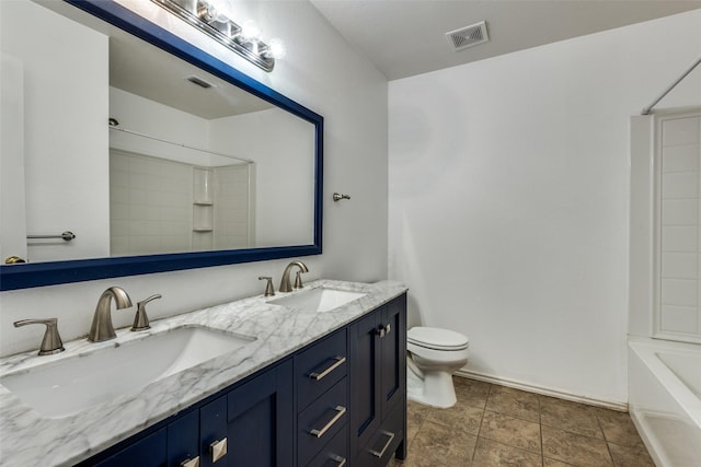 12748 Gillon Dr, Frisco, TX 75035 - full bathroom featuring toilet, double vanity, shower / bath combination, and baseboards