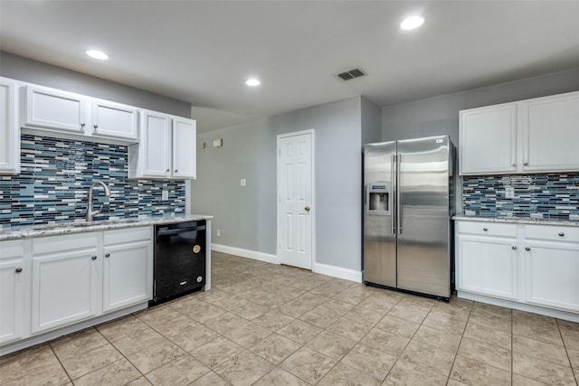 12748 Gillon Dr, Frisco, TX 75035 - kitchen with stainless steel fridge, black dishwasher, a sink, tasteful backsplash, and white cabinetry