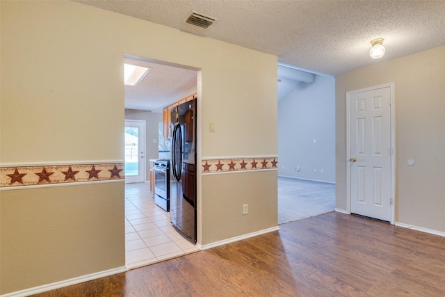 2009 Briargate Ln, Mesquite, TX 75181 - spare room featuring a textured ceiling and light wood finished floors