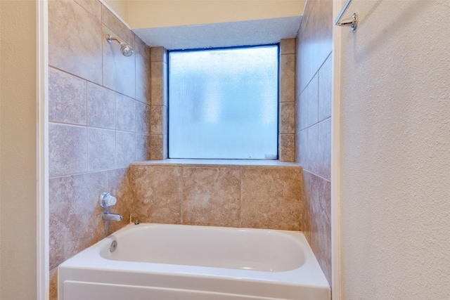 2009 Briargate Ln, Mesquite, TX 75181 - full bathroom featuring a bath and a textured wall