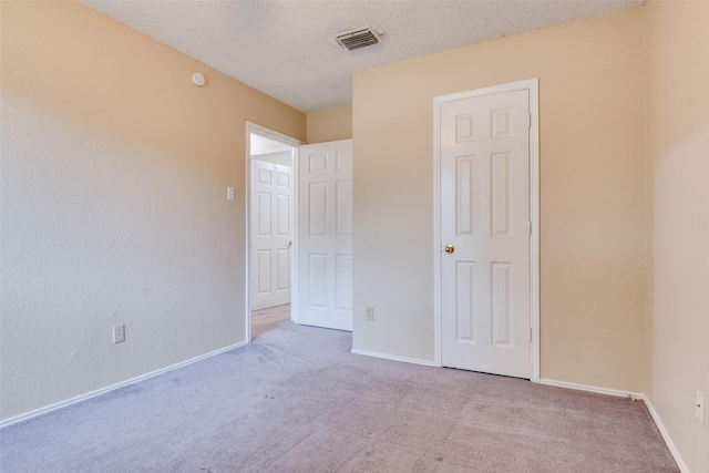2009 Briargate Ln, Mesquite, TX 75181 - unfurnished bedroom with carpet floors, a textured ceiling, and baseboards