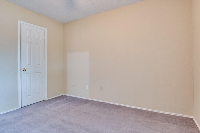 2009 Briargate Ln, Mesquite, TX 75181 - unfurnished room featuring carpet floors, baseboards, and a textured ceiling