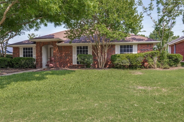 single story home featuring brick siding and a front lawn