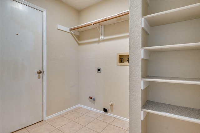2009 Briargate Ln, Mesquite, TX 75181 - washroom with hookup for a gas dryer, electric dryer hookup, light tile patterned floors, hookup for a washing machine, and baseboards