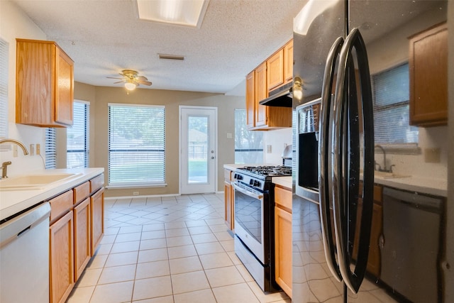 2009 Briargate Ln, Mesquite, TX 75181 - kitchen with stainless steel appliances, a sink, light countertops, under cabinet range hood, and a ceiling fan